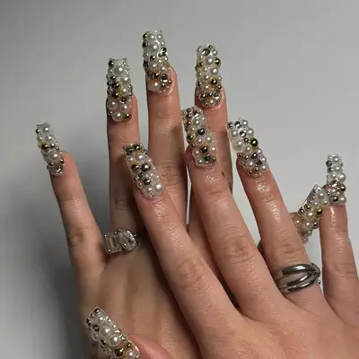 all-over pearl and gold studded manicure 