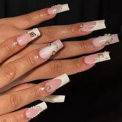 a square french manicure with pearls and initials