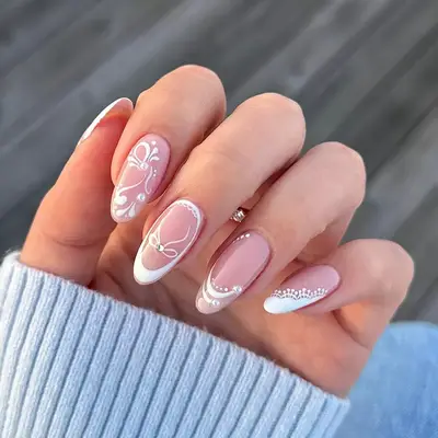 a manicure with vintage designs and pearl accents
