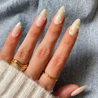 a pearlescent manicure with pearly polish and pearl accents