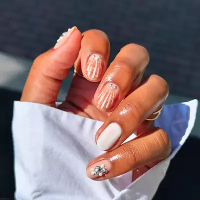 a shell manicure with pearl accents