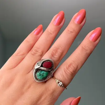 Coral pink nails with subtle shimmer finish, viewed close up