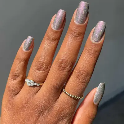 Sparkly silver nails with iridescent finish, viewed close up