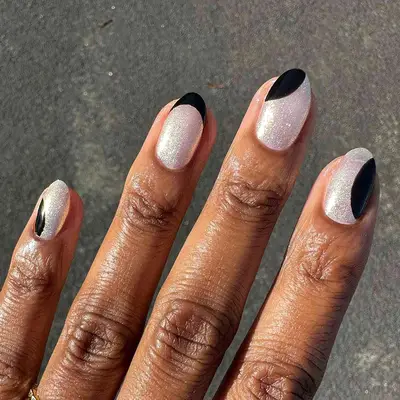 a silver shimmer manicure with black accents