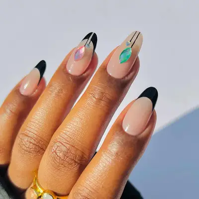 a black french manicure with subtle ornament details