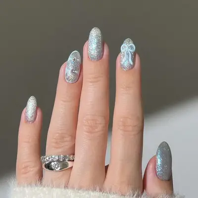 a shimmery glittery manicure with bow details
