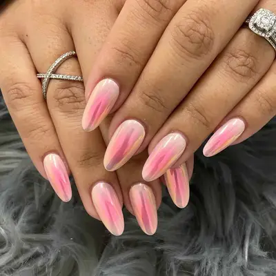 a pink aura manicure topped in chrome