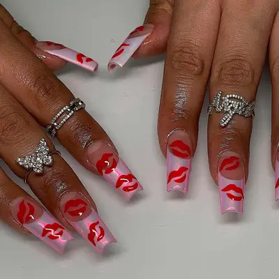 a French manicure topped with chrome and kiss designs