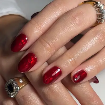 a shimmery red foil manicure