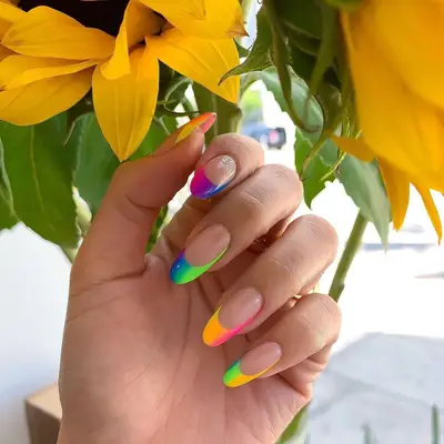 A manicure with rainbow gradient French tips