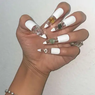 A half white, half clear almond shaped manicure with gel accents