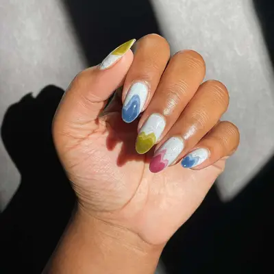 A French manicure with geode-esque tips and a granite base