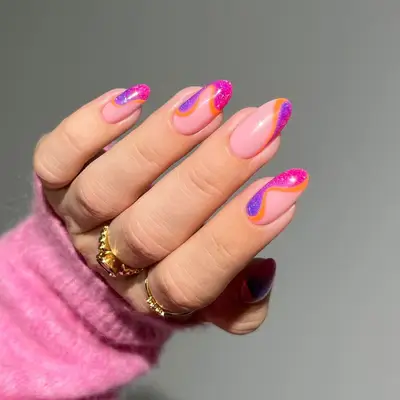 A manicure with swirling tips in pink, purple, and orange