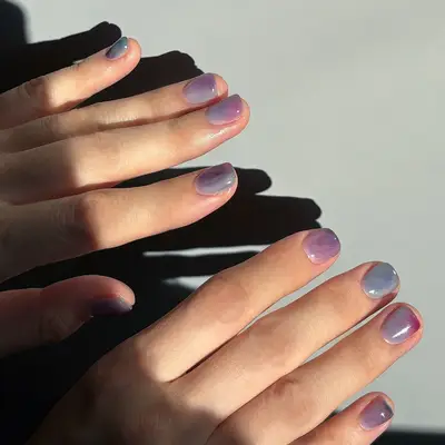 Close-up of hands showing a manicure with glossy polished nails