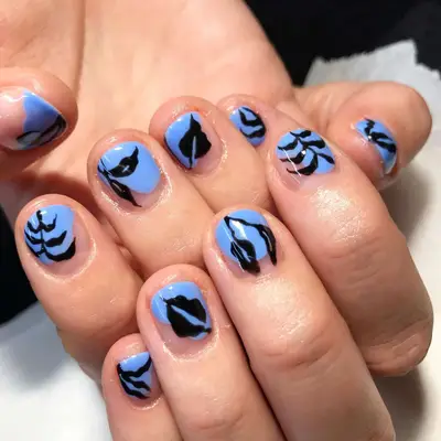 Negative space shadowed leaves manicure with a periwinkle background and black leaf designs