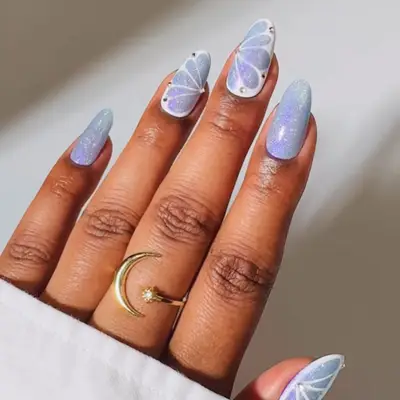 Periwinkle manicure with shimmer finish and butterfly design on accent nails