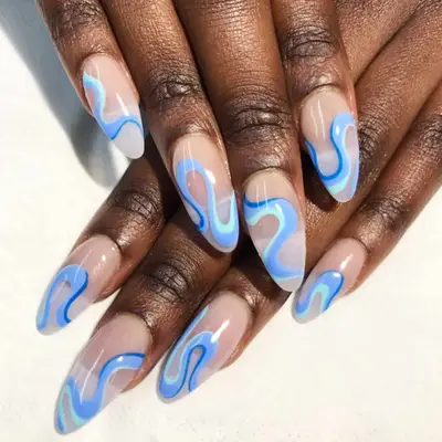 Nude nails with periwinkle swirls.
