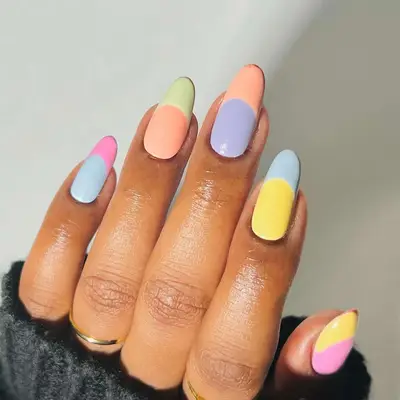 Two-tone pastel French manicure with shades of blue, pink, orange, green, and yellow