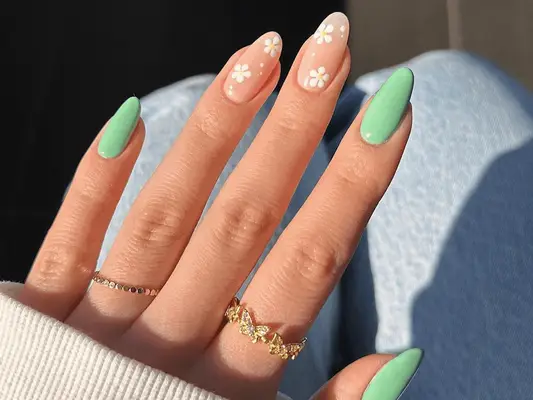 mint green manicure with white floral designs