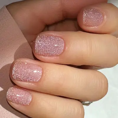 Close up of a glittery pink manicure