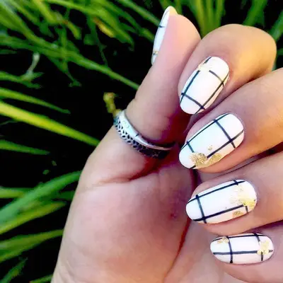White and black plaid nails with gold splotches