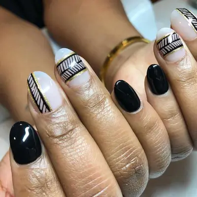 Black and gold manicure with art deco stripe design