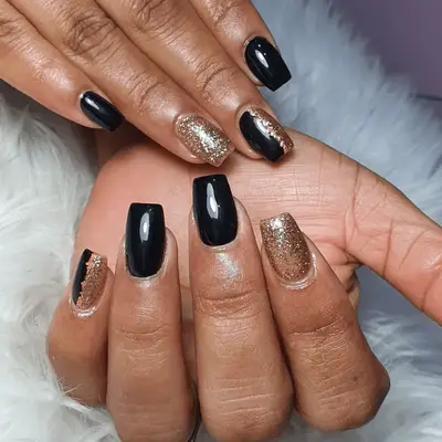 Pale neutral manicure with body outline designs and black and gold nail stickers