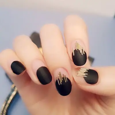 Black manicure with gold thin bar design