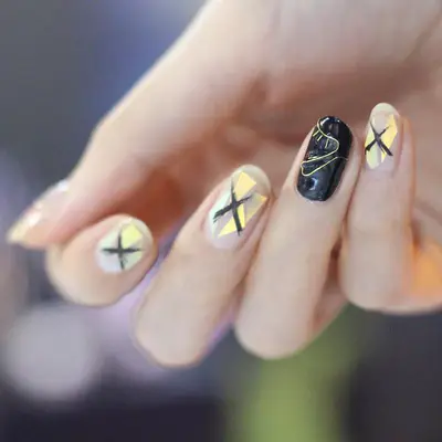 Black and gold nail design with wire and abstract strokes