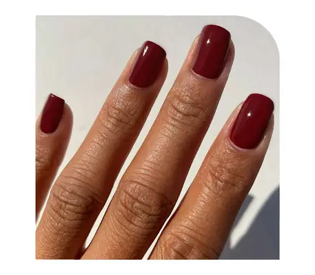 Model wearing red wine nail polish