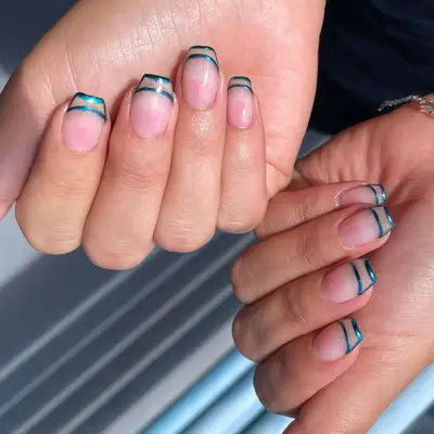 negative space manicure with plain base and blue chrome negative space french tips