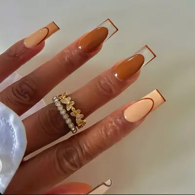 zoomed in image of negative space manicure with brown tones and clear french tips