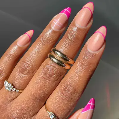 negative space manicure with nude base and hot pink french tips lines