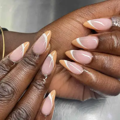 A French manicure with curved, cream-colored tips