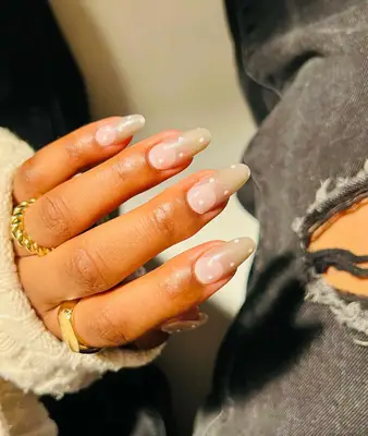 Close up of a manicure with neutral tips and white polka dots