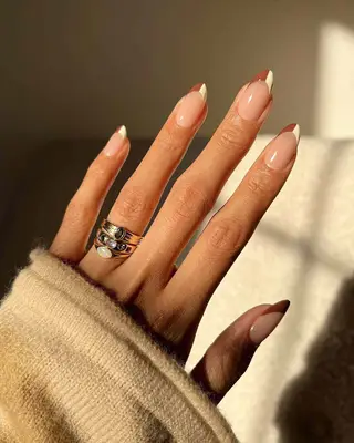 A French manicure with half brown, half white tips