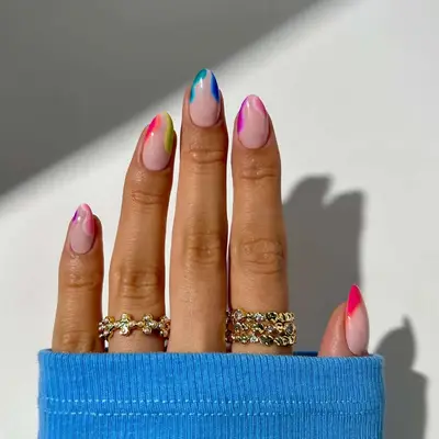 Manicure with pink base and rainbow squiggle tips 