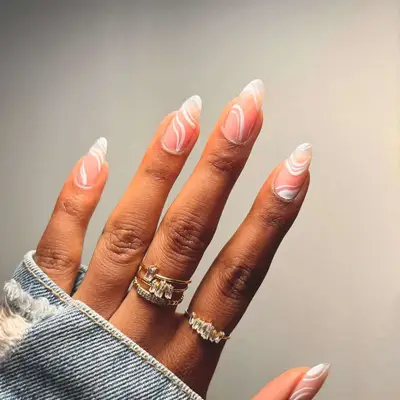 Manicure with negative space base and white swirl designs