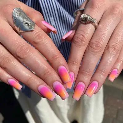 Manicure with hot pink and orange airbrush design