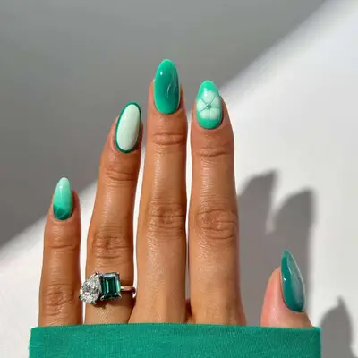 Mint and teal green manicure with aura and floral nail designs