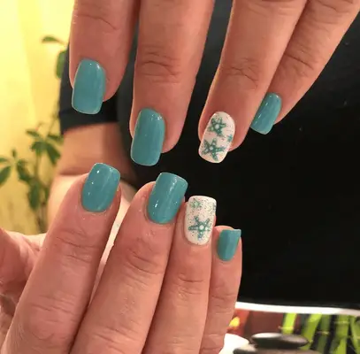 blue acrylic manicure with starfish-themed accent nails