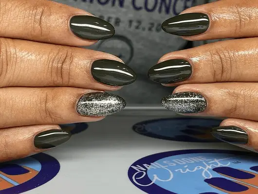 short acrylic nails with glossy black polish and silver glitter accent nail