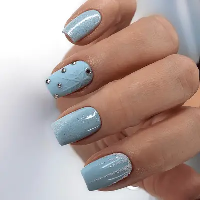 Square-shaped baby blue acrylic nails with icy motifs
