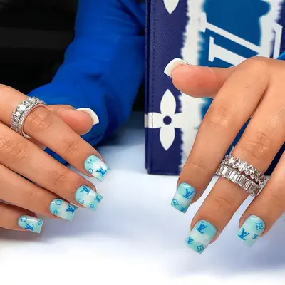 Blue, square-shaped acrylic nails with LV logo