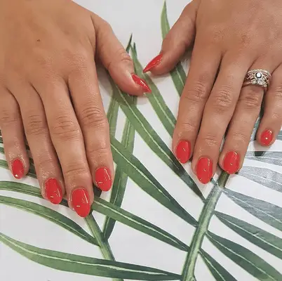 short acrylic manicure with classic red nails