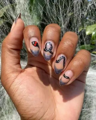Hand-painted snake nail art. 