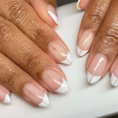 Classic French manicure with a streak of glittery gold