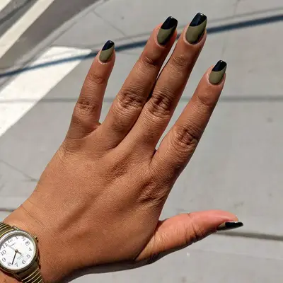 A two-toned olive and black French manicure. 