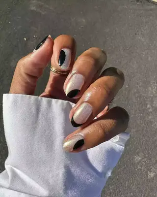 A black swirl French manicure with shimmer. 