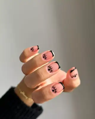 Graphic artwork on a French manicure. 